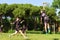 Group of young teenagers people in team wear playing a frisbee game in park oudoors. jumping man catch a frisbee to a teammate in