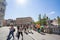 Group of young tourists, youngsters, teenagers, male and female, walking in the city center of Ljubljana wearing a facemask