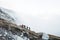 Group of young travelers walking on volcanic mountain, Kawah Ijen crater in Indonesia