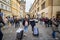Group of Young travellers walking with their suitcases in the old town of prague, with a speed blur, the landmarks of the bridge