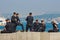 Group of young turkish policeman officers in stylish police uniform have a rest on the Bosphorus blurred background.