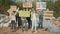 Group of Young Volunteers in Gas Masks With a Poster Calling to Take Care of the Environment Against