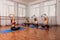 Group of young womans with magic pilates ring in Sportswear Leggings and Tops, stretching in the gym, on a yoga mat near