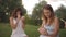 A group of young women apply patterns on clay products, decorate them with tools, shovels, sticks in a meadow, in nature