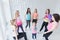 Group of young women with a baby girl having a chat after a fitness dance class