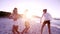 Group of young women dancing on the beach