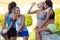 Group of young women doing stretching in the park.