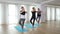 Group of young women doing yoga workout exercise at a gym