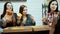 Group of young women eating pizza together.