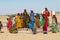 Group of young women and kids collect water from a public road side well  in the Great Thar desert in Jamba, India.