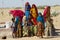 Group of young women and kids collect water from a public road side well  in the Great Thar desert in Jamba, India.