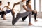 Group of young women practicing yoga, doing anjaneyasana exercis