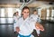 Group of young women practising karate indoors in gym.