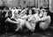 Group of young women sitting on the floor of a living room talking