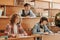 Group of youthful interracial students in casualwear making notes in copybooks