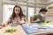 Group of youths with face masks playing a board game