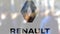Groupe Renault logo on a glass against blurred crowd on the steet. Editorial 3D rendering
