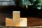 Groupped wooden square blocks on dark wooden table