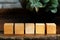 Groupped wooden square blocks on dark wooden table