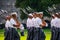 Groups of Army cadets in formation holding rifles and marching on the West Point Military Academy parade field