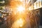 Groups of busy people walking down the crowded sidewalks of 14th Street in New York City with the summer sunset shining bright