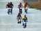 Groups of children with full suit of bicycle riding gear race each other riding the BMX