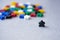 Groups of colorful meeples isolated on gray background. Leader of people nation. Election campaign. White crow