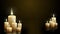 Groups of decorative paraffin candles with flickering flames. Warm dark festive animated background