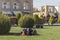 Groups of Iranian people are resting on grass in the Imam Square
