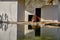 Groups of ring-tailed Lemurs and their reflection on small pond in a Zoo.