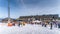 Groups of skiers, kids and adults learning how to ski with instructors