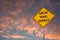 `GROW WIND ENERGY` ROAD SIGN AGAINST SUNSET CLOUDS