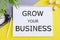 Grow your business text message written in Notebook. Business concept