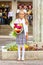 Grower Baby girl first-grader with bouquet of flowers at the school