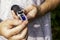 the grower holds a refractometer in his hands to determine the amount of sugar in grape juice