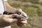 the grower holds a refractometer in his hands to determine the amount of sugar in grape juice