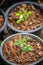 Growing green tree in pot coverred by brown coconut shell residue