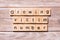 Growing victim number word written on wood block. growing victim number text on wooden table for your desing, coronavirus concept