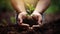 growth and nurturing, with hands delicately holding soil from which a plant is growing.