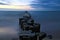 Groynes protruding into the horizon in the Baltic Sea. Long exposure with muted colors