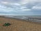 Groynes on Winchelsea Beach to stop the erosion by the tides and weather. Pebble beach with sea and sky landscape - East Sussex UK