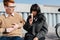 Grumpy couple sitting on the stairs outdoors, eating ice cream