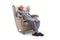 Grumpy old man in pajamas seated in an armchair