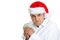 Grumpy young man in santa\'s hat possessive about his money