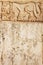 Grunge background with stucco texture and bas-relief carving of