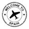 Grunge black welcome to Spain word with airplane icon round rubber stamp on white background