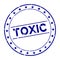 Grunge blue toxic word round rubber stamp on white background