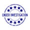 Grunge blue under investigation word with star icon rubber stamp on white background