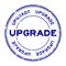 Grunge blue upgrade wording round rubber stamp on white background