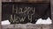 Grunge chalk inscription on the board happy new year. Timelapse